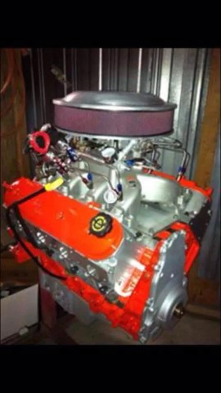 Orange performance engine with carburetor and air cleaner in the workshop
