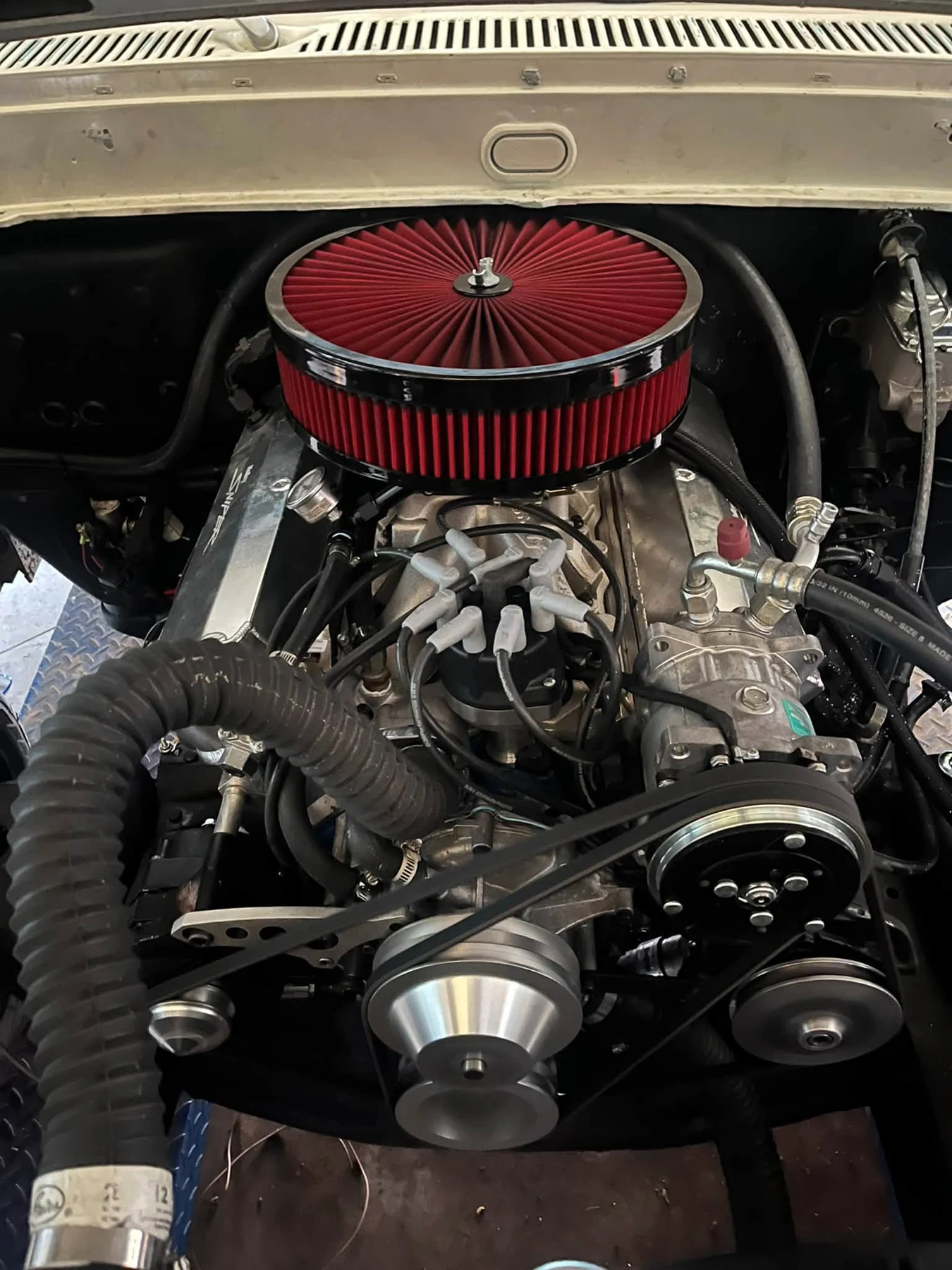 Classic truck engine bay with a red air filter