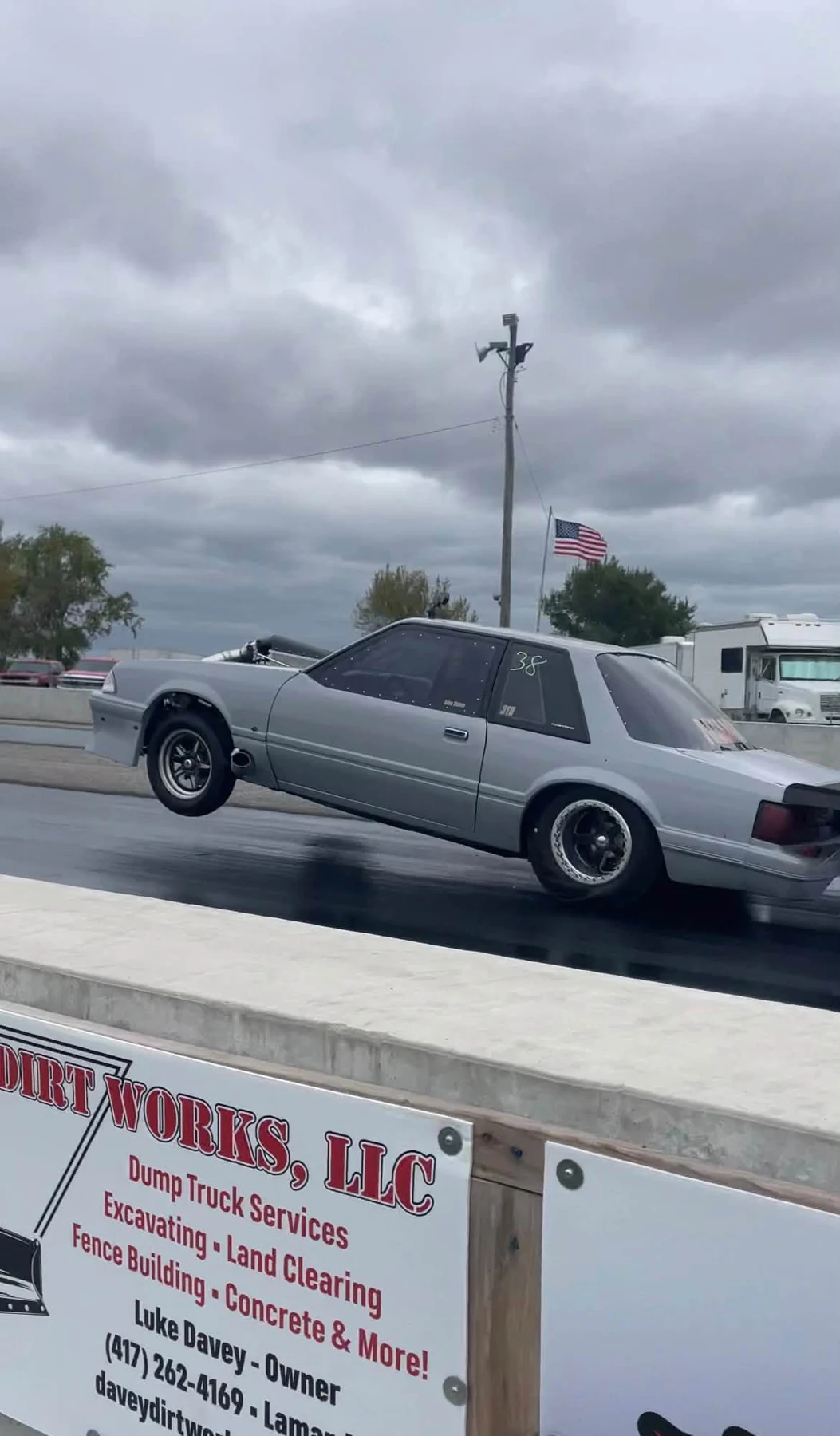 Silver Mustang preparing for a run at a drag strip